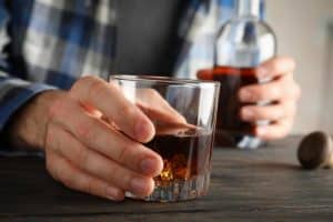 guy with alcoholic nose drinking