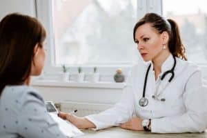 Two people discuss risk factors for opioid addiction
