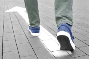 Person walking and wondering, "What happens after rehab?"