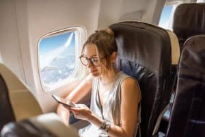 Woman searching "How do you fly sober?" at an airplane