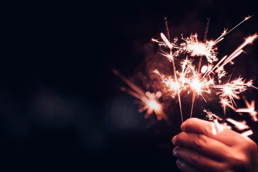 A hand holding a sparkler, its owner having decided on a sober New Year's Resolution