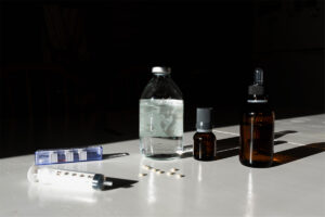 A closeup shot of syringe and medicals on a white background